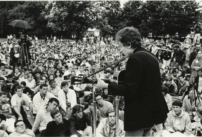 Bob Dylan at concert in front of a crowd.